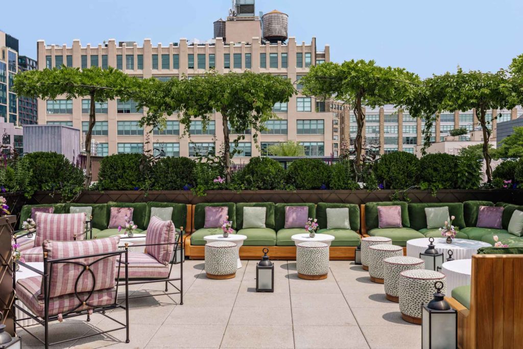 Rooftop terrace with pink and white seating and green accents