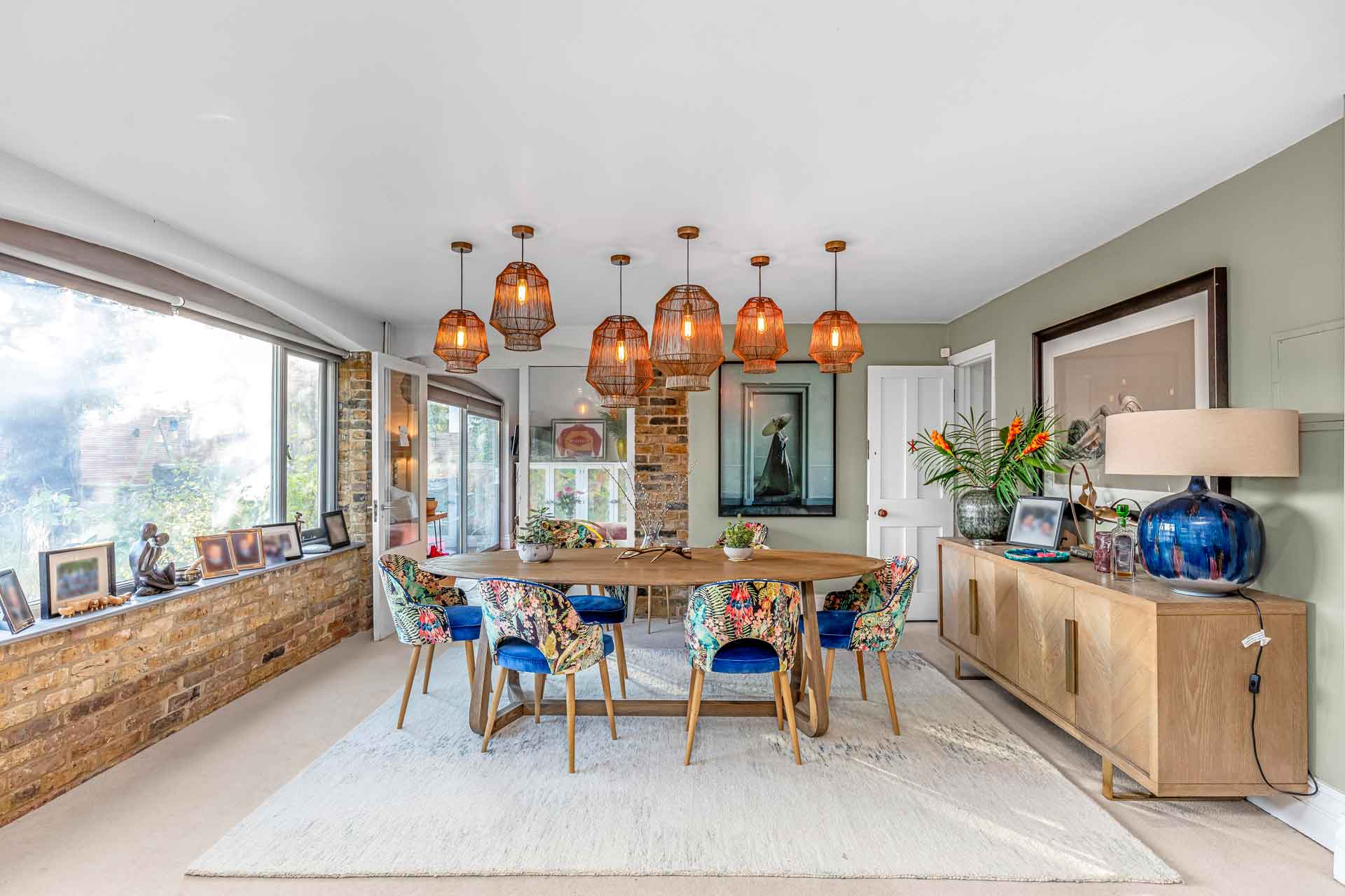 Large dining room with blue chairs and oak furniture.