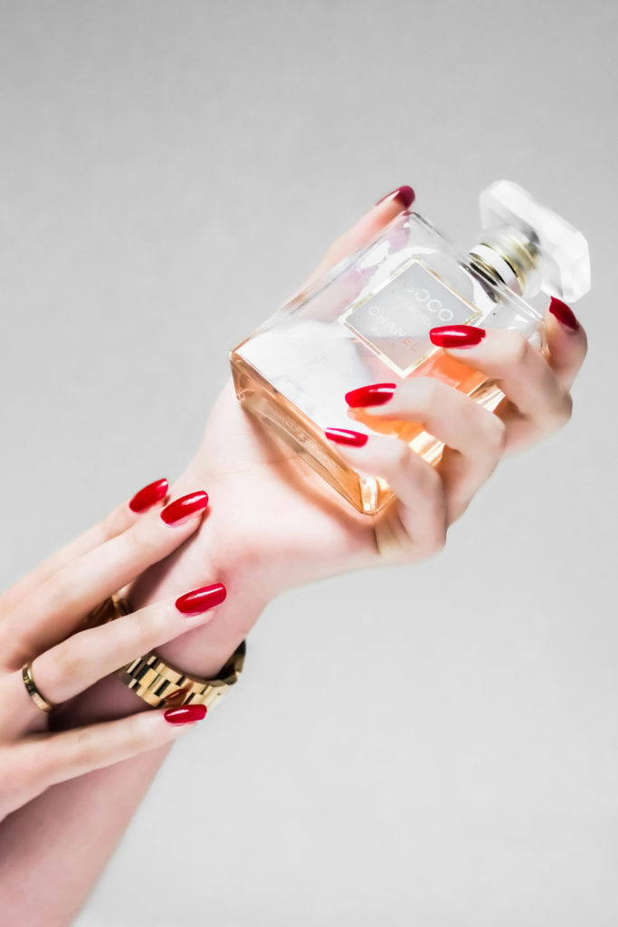 Hands holding perfume bottle | pheromone perfume