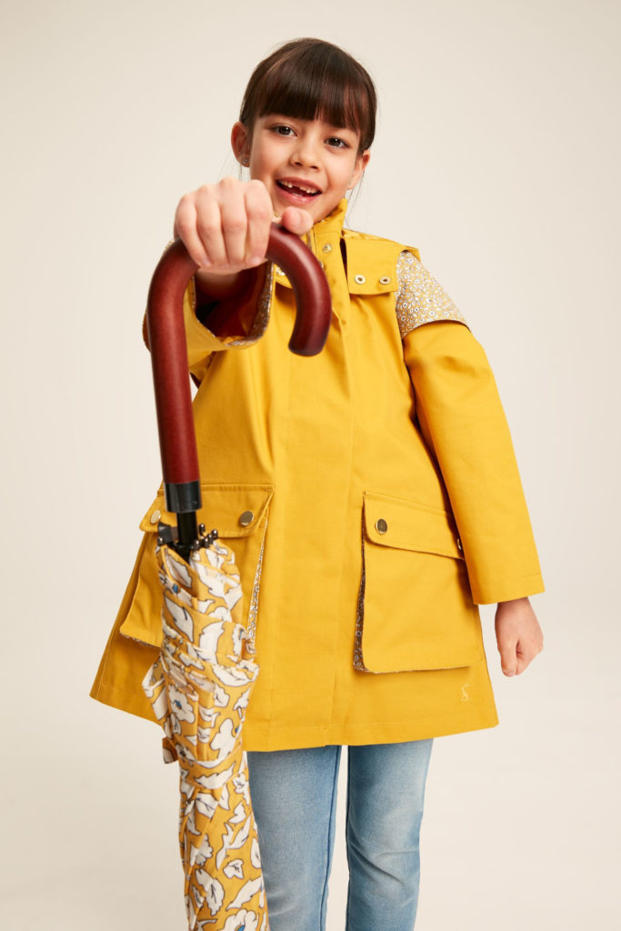 Little girl in yellow rain jacket