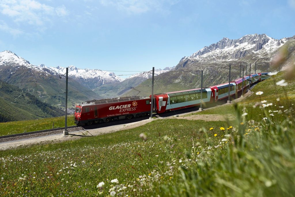 Red Glacier Express train travelling through the Swiss Alps