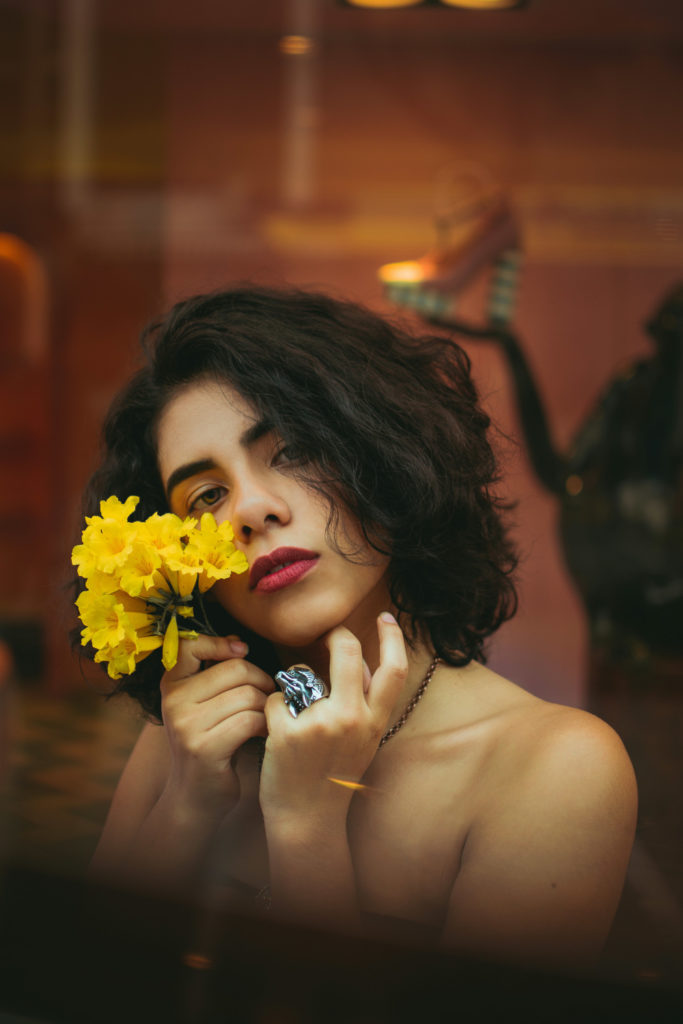 Woman with macro bob holding flower