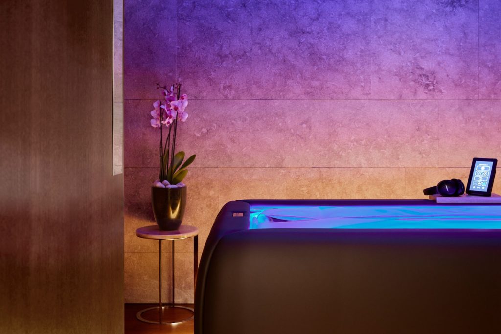 Zerobody Dry Float bed with blue LED lights in a marble treatment room