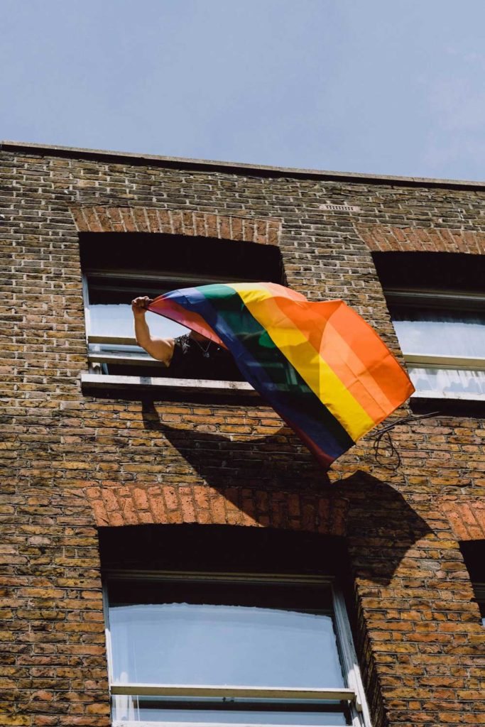 pride flag flying out a window