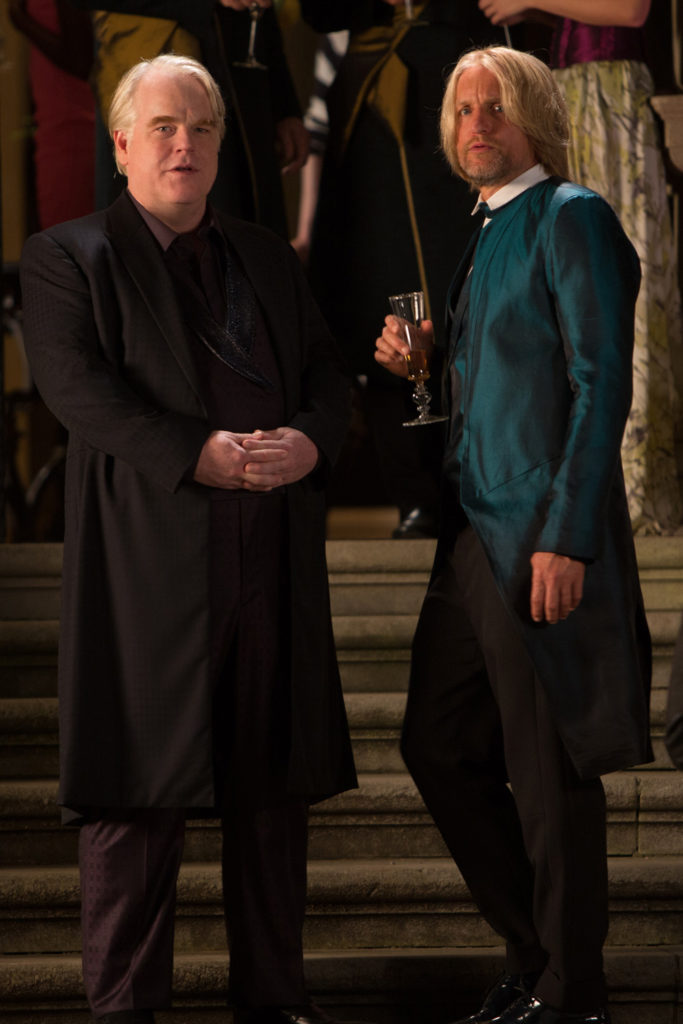 (L-R) Phillip Seymour Hoffman as Plutarch Heavensbee and Woody Harrelson as Haymitch Abernathy in The Hunger Games: Catching Fire