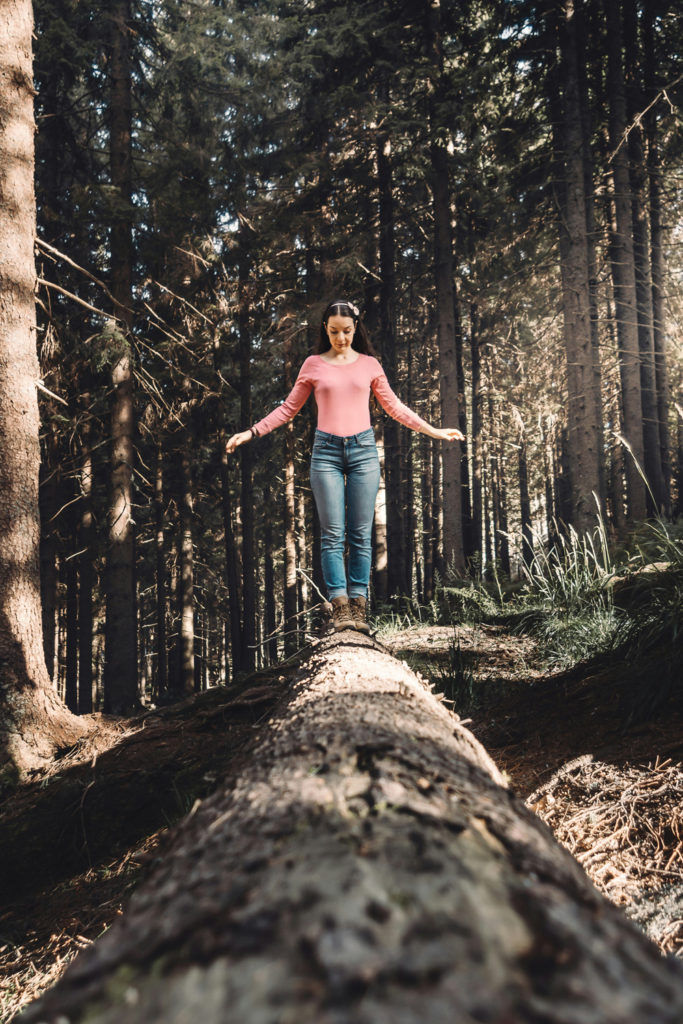 A woman balanced on a log