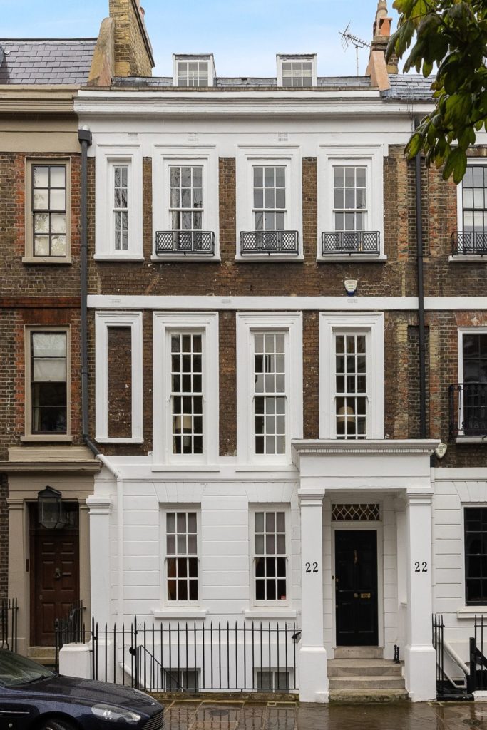 Queen Anne terraced house with a white stucco portico