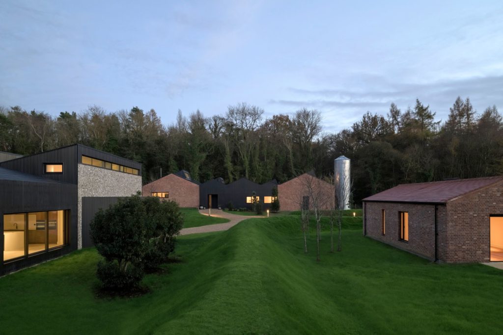 Wood-panelled eco homes with lawns in between