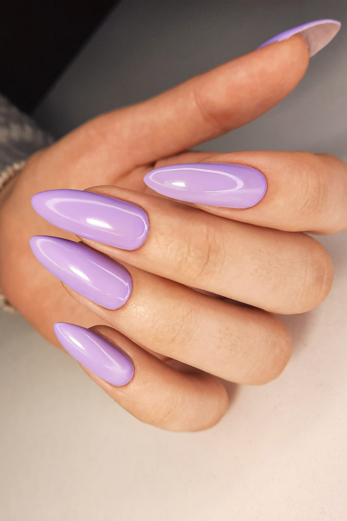 Hand with purple stiletto nails