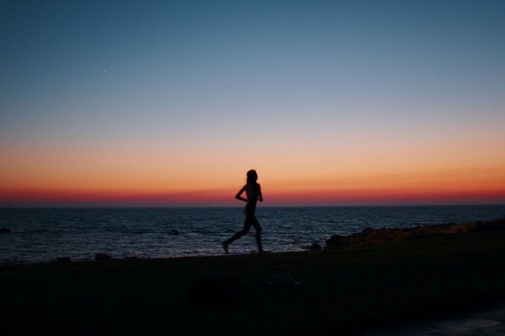 Woman running at sunset on the beach