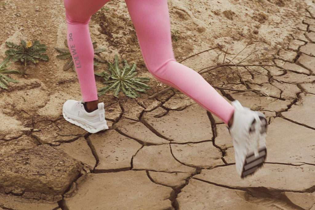 Close up of person running in pink leggings and Loewe sneakers