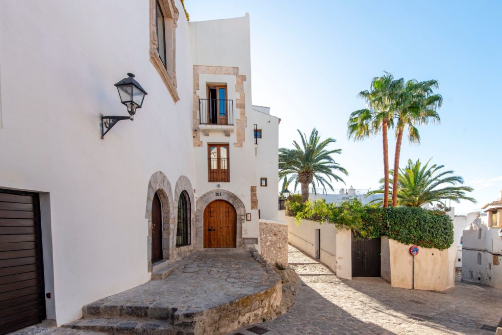 Ibiza villa with stone archways and palm trees