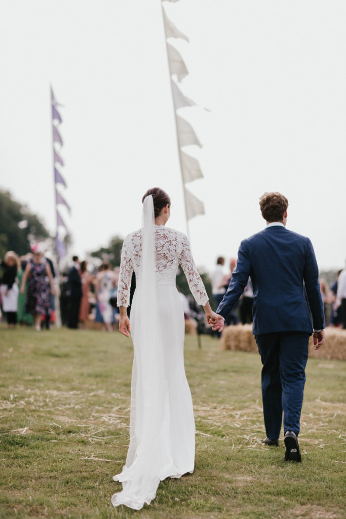 Bride and groom entering a festival ground