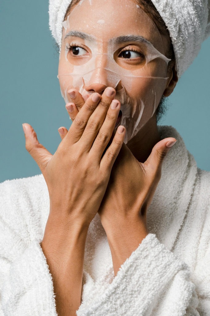 Woman wearing mask and towel