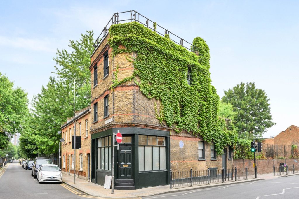 Ivy-clad brick pub with black front door