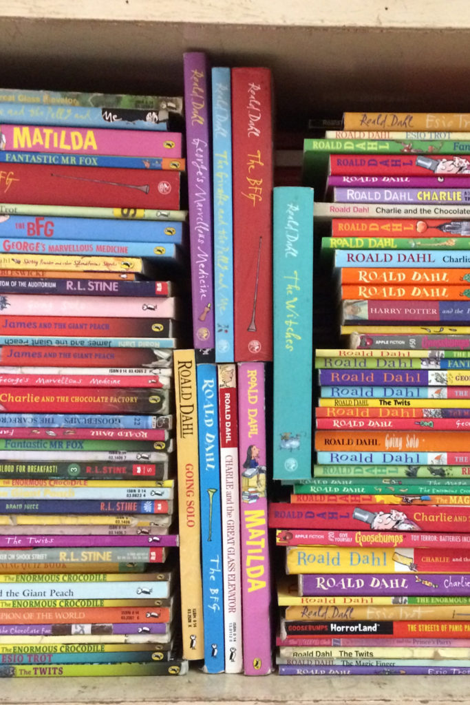 A bookshelf filled with books by Roald Dahl