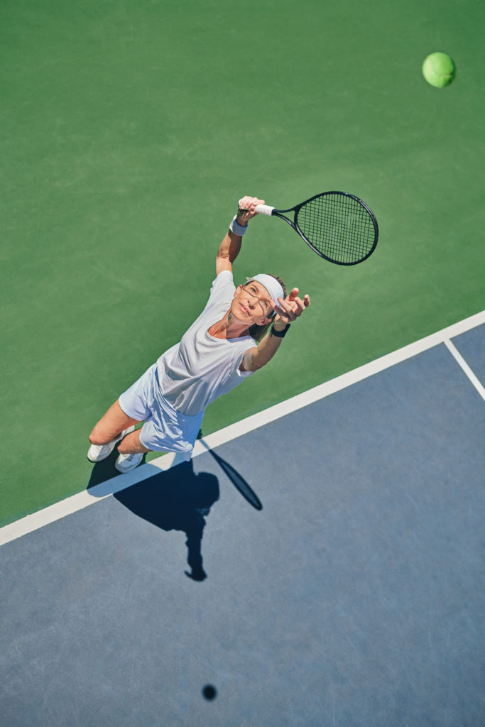 Tennis serve, sport and woman on outdoor court