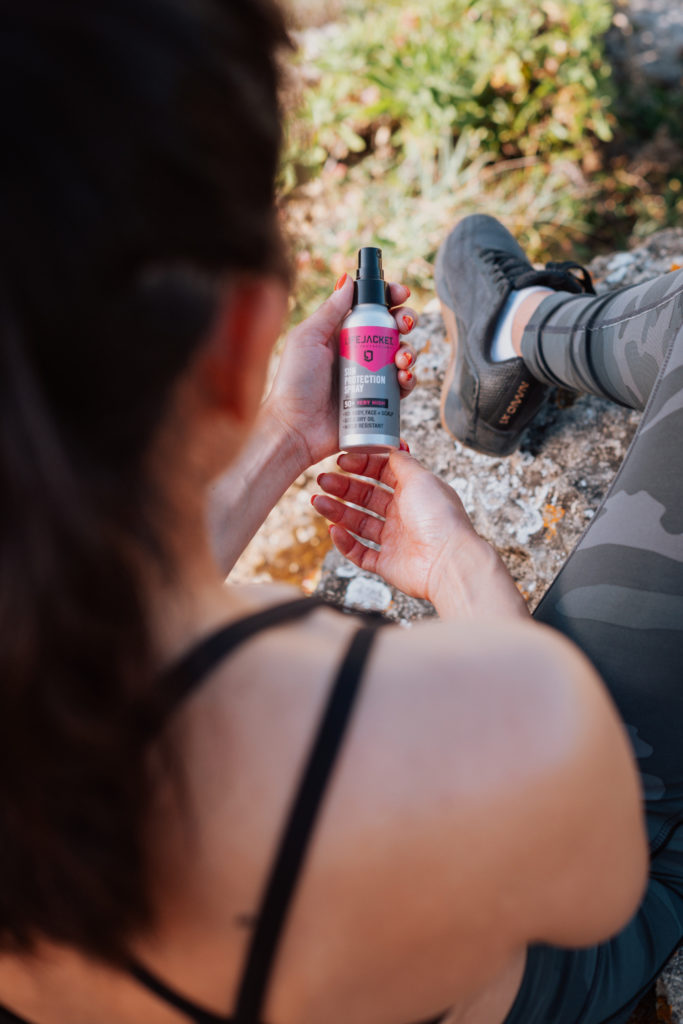 Over-shoulder view of women looking at suncare product