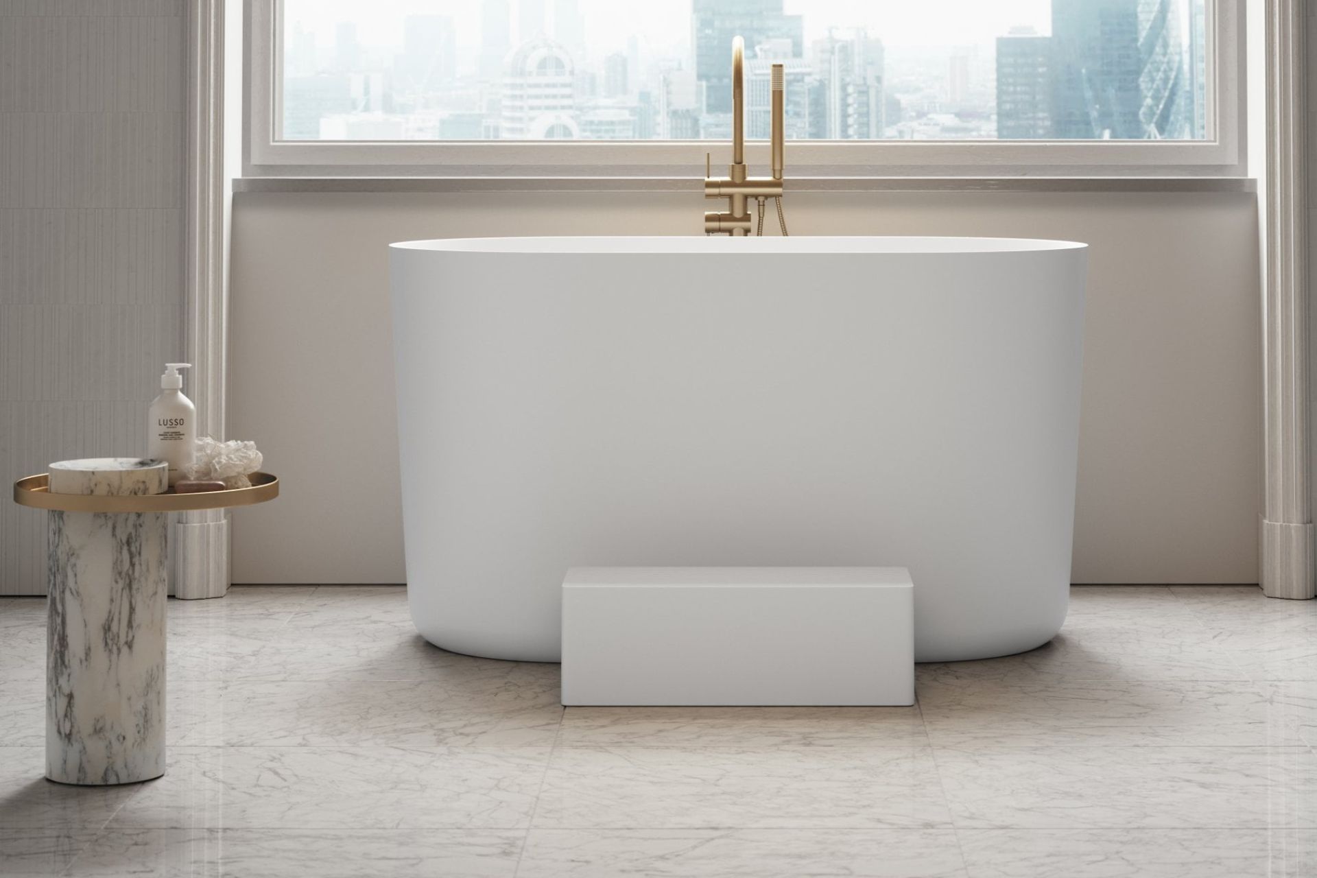 Minimalist bathroom with curved freestanding bathtub and gold fittings