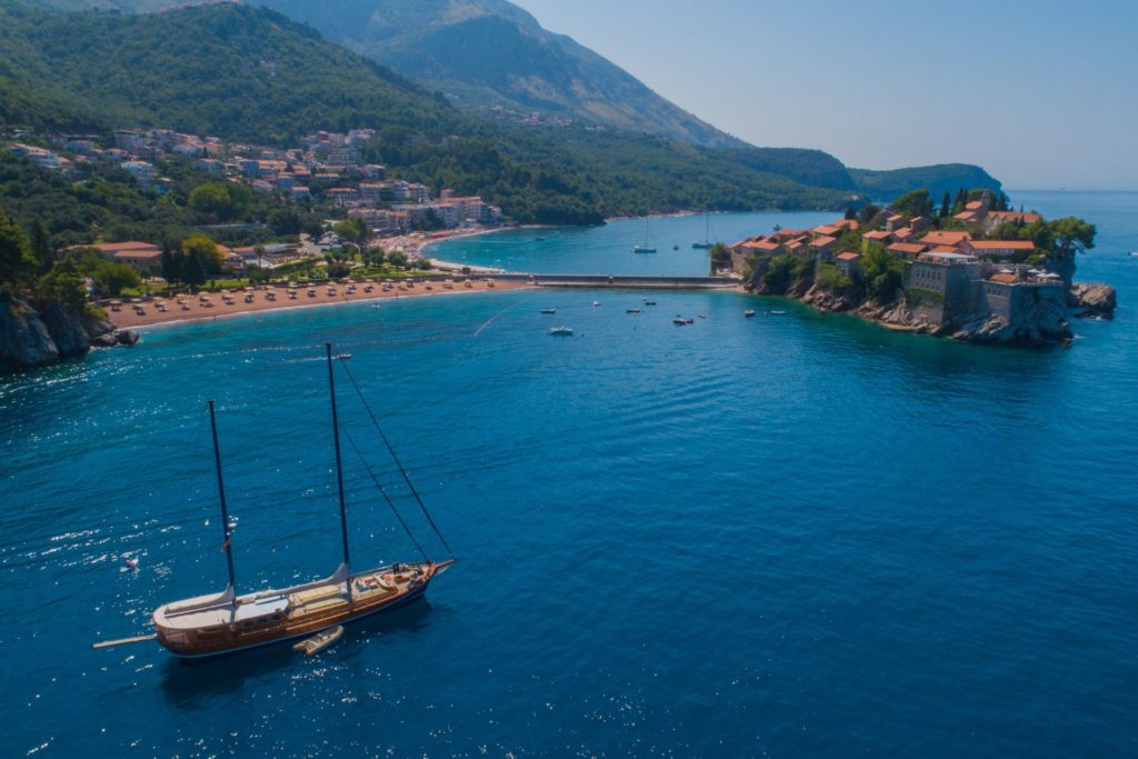 Gulet boat next to Sveti Stefan, a private island in Montenegro