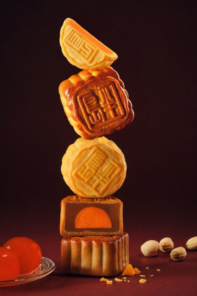 Peninsula mooncake pastries stacked against a black background