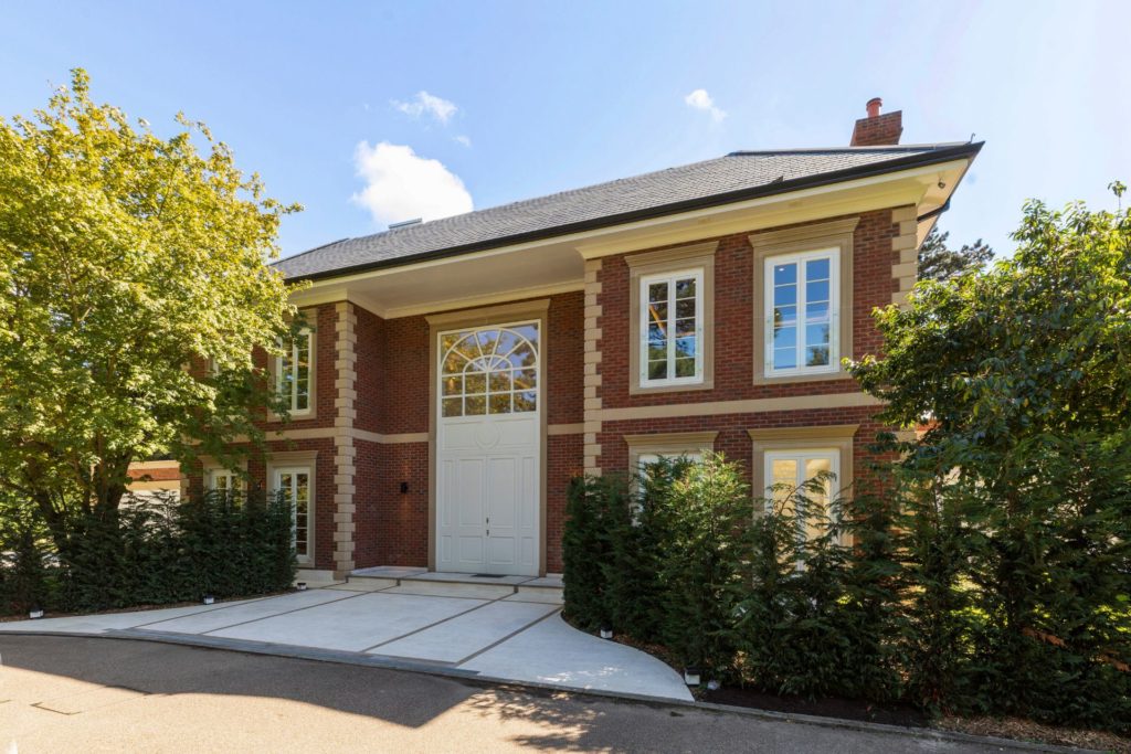 Neo-Georgian red brick mansion with driveway