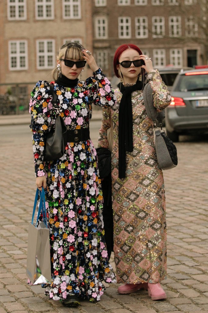 Women in patterned dresses posing for pictures | AW24 Hair Colour Trends