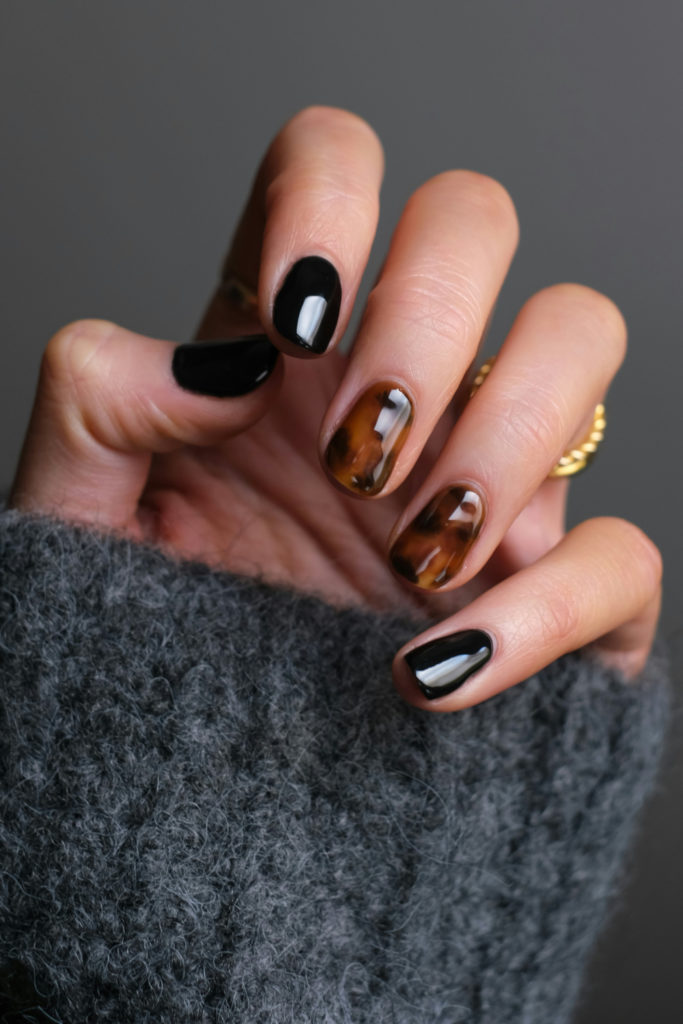 Hand with tortoiseshell nails