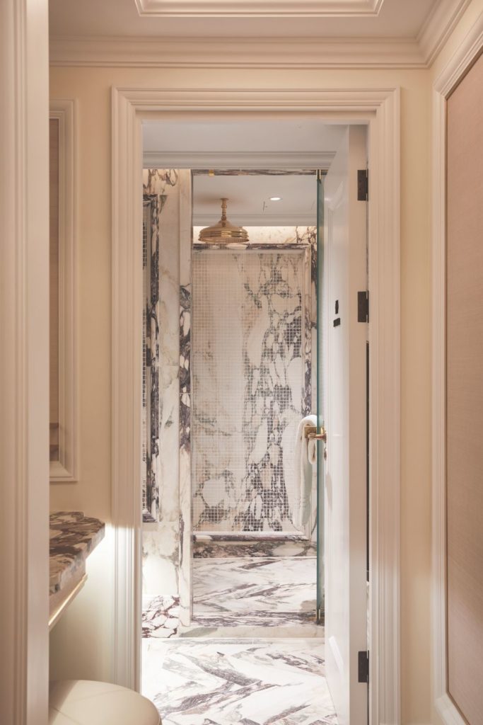 Marble clad treatment room with gold shower head