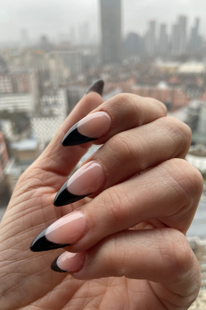 Hand with black French tips | AW24 nail trends