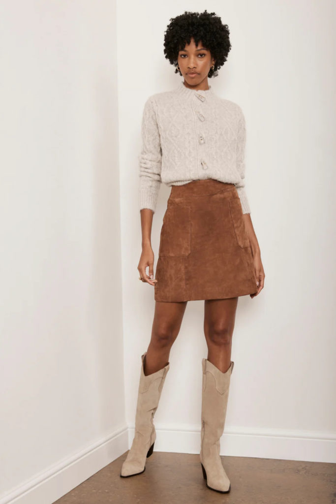 Woman in jumper, boots and skirt