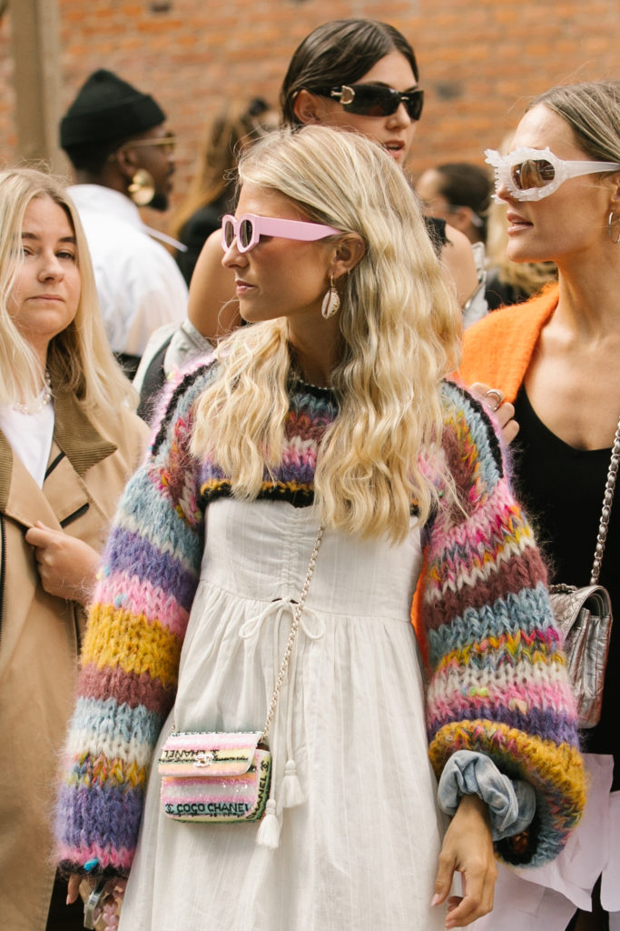 Close up of girl with churro waves, surrounded by multiple people