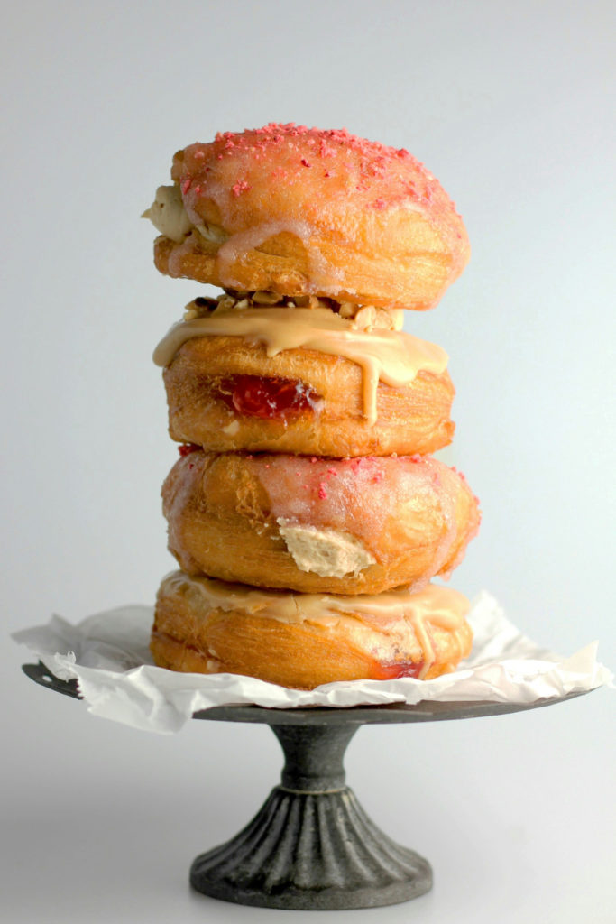 Stack of jelly donuts with blush-coloured frosting