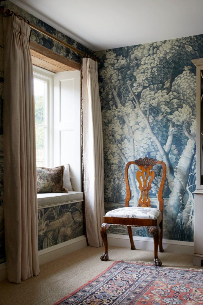 Reading nook with blue wallpaper and beige curtains