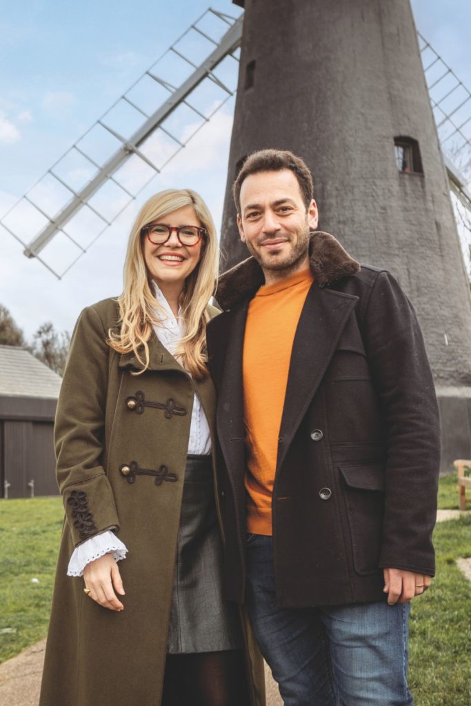 Emma Barnett and her husband standing in front of a windmill