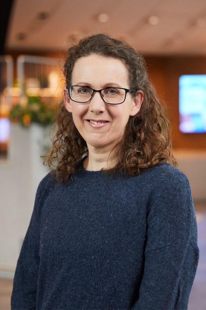 Portrait of Leah Robson wearing a blue jumper