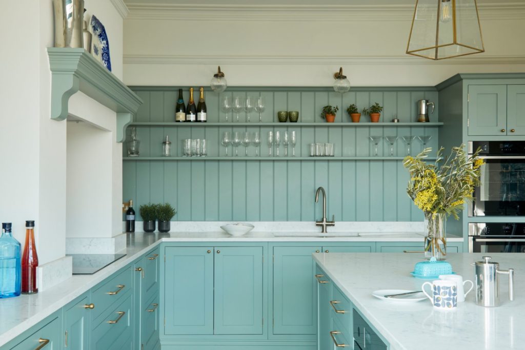 Pastel blue kitchen with white worktops