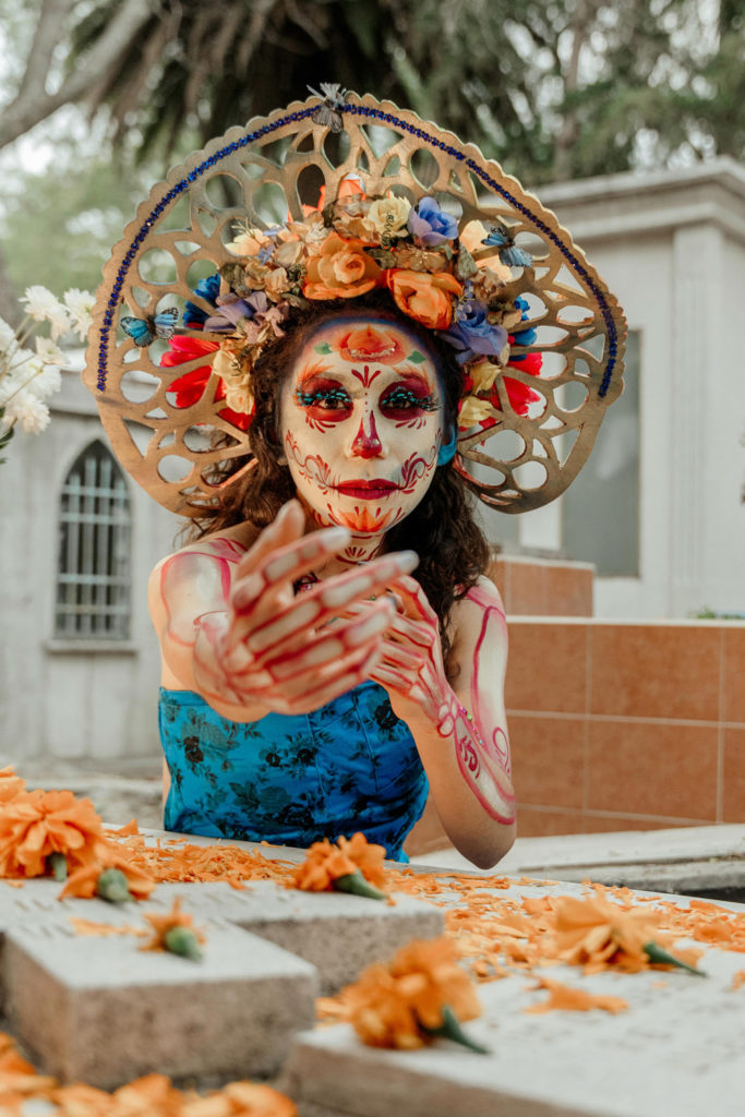 A Hispanic woman in Day of the Dead costume