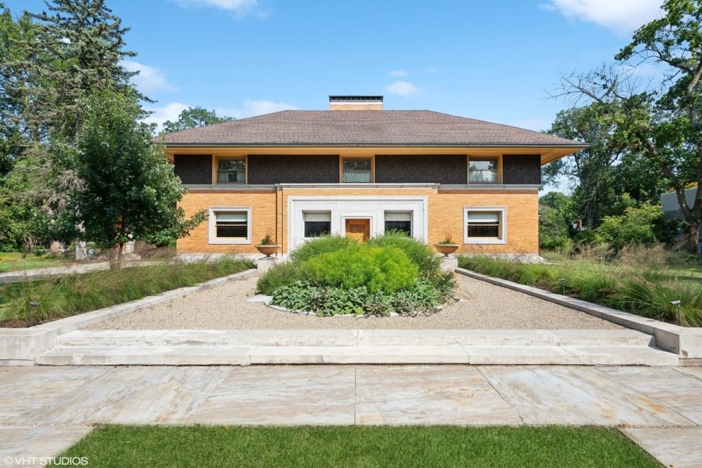 Exterior of Frank Lloyd Wright home with tall windows and large eaves