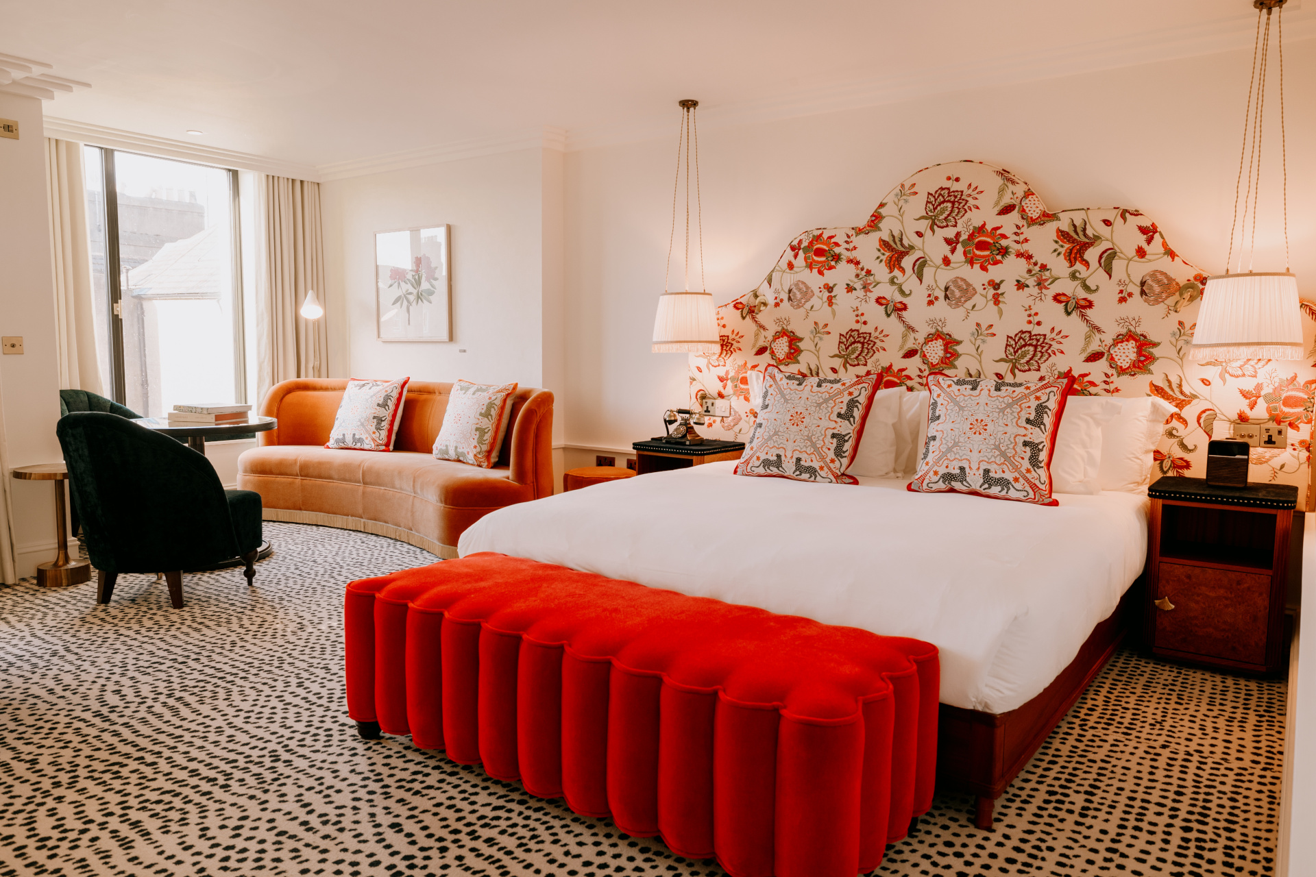 Room with red and white bed and floral headboard