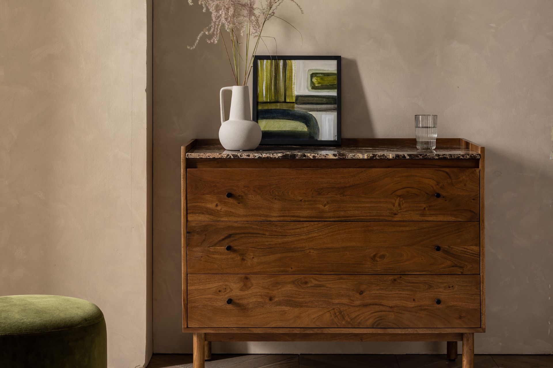 Dark wooden chest of drawers with a marble top